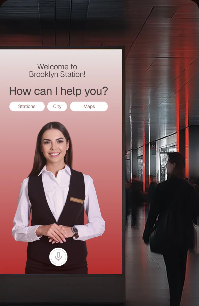 Ein Visual Agent begrüßt Reisende an einem Terminal im Bahnhof
